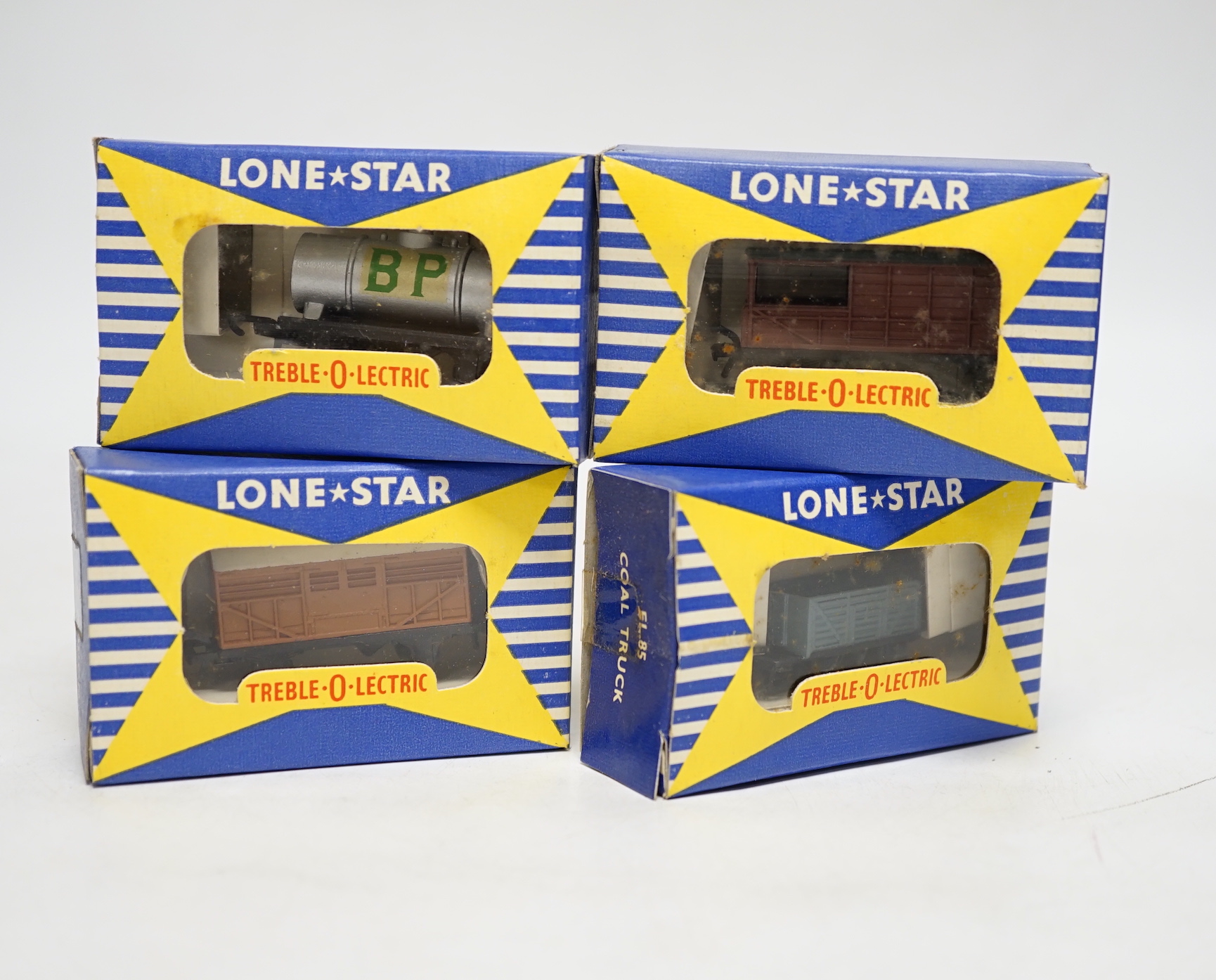 A collection of Lone Star 000 gauge model railway, contained within two original trade boxes with most items, appearing boxed as new, comprising coal trucks, brake vans, petrol, tank, wagons, distance, signals, home, sig